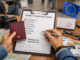 How To Apply For A Schengen Visa Traveler reviewing Schengen visa application documents with passport and checklist before embassy appointment