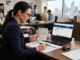The Complete Process of How to Get the Australian Skilled Visa Person reviewing Australian skilled visa documents and passport